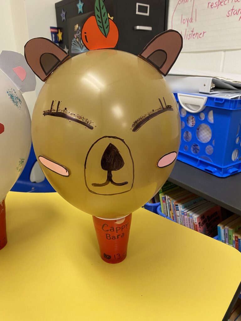 Student made capybara parade balloon with paper ears inspired by Balloons Over Broadway