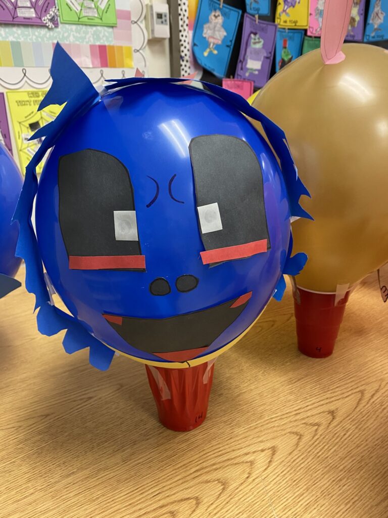Student made blue character parade balloon with paper hair inspired by Balloons Over Broadway